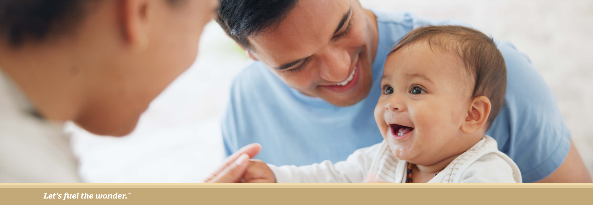 Smiling parents engaging playfully with their happy baby, creating a joyful moment