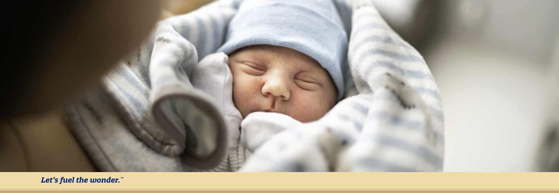 baby swaddled and sleeping in parents arms