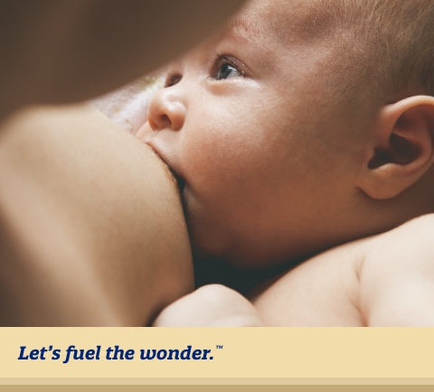 Baby breastfeeding from parents nipple while being held in breastfeeding parent's arms. Baby is looking off to their right as they are breastfeeding.