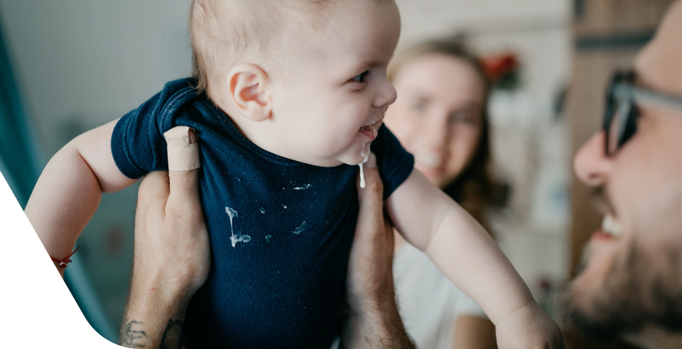 How can I keep my baby from spitting up after every meal?